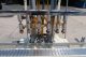 MRM 6 Spout Semi-Automatic Pressure Gravity Filler, with Motorized Conveyor